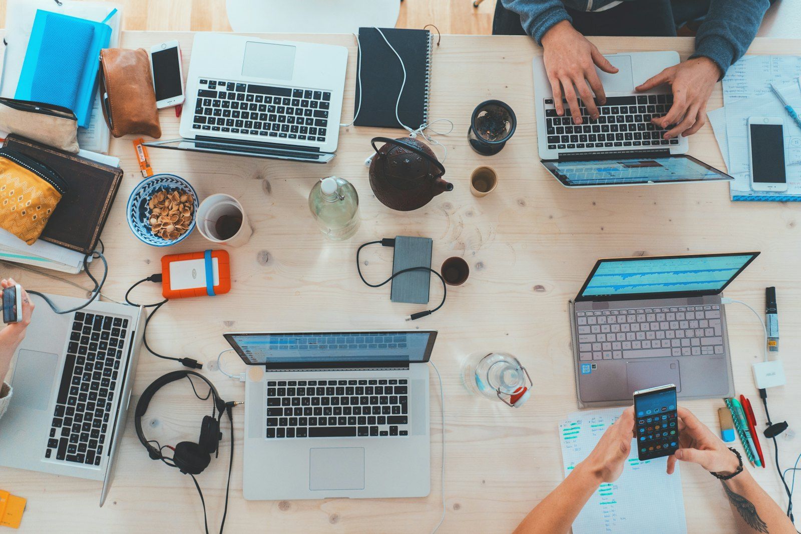 Colleagues working side by side on laptops at a shared table