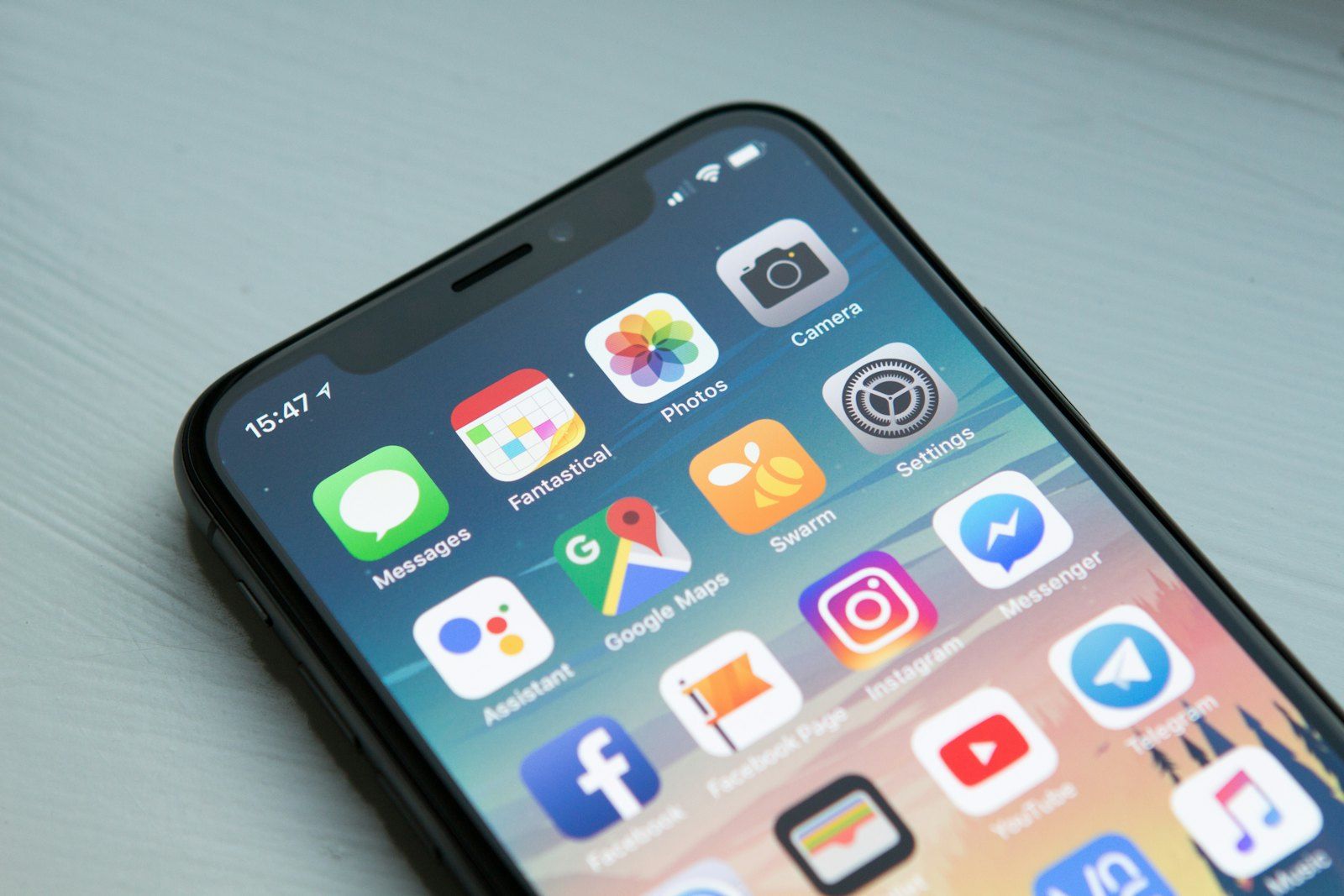 A hand holding a smartphone showing an app
